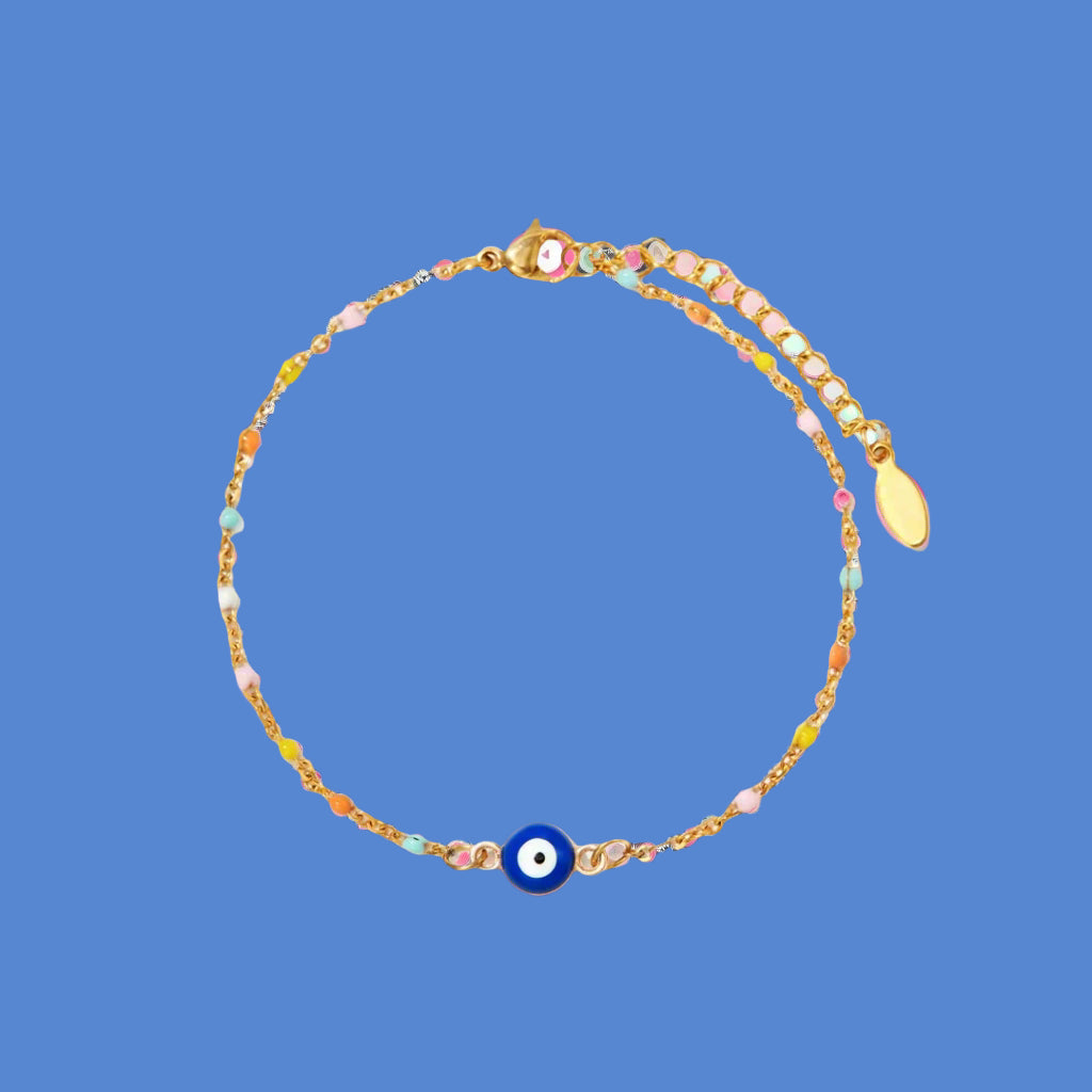 Multicolored beaded bracelet with a blue evil eye charm on a white background